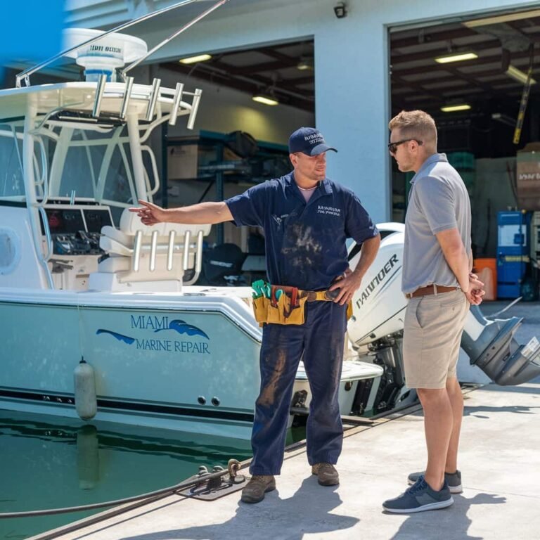 Boat mechanic explaining common types of boat repairs in Miami marina under sunny weather.